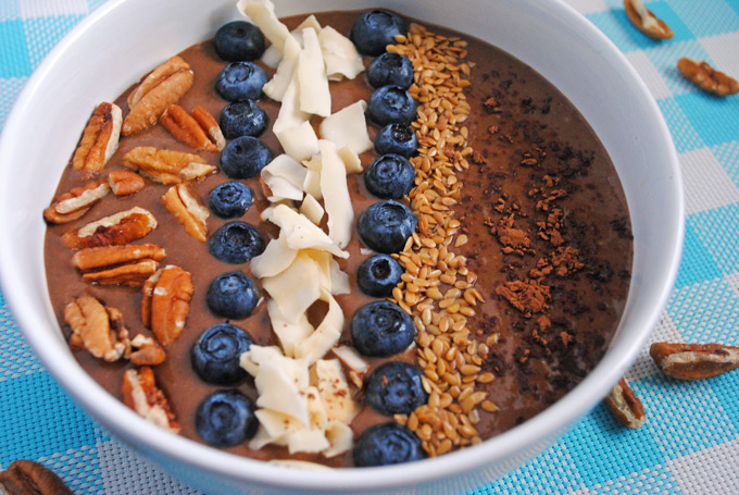 chocolate smoothie bowl on blue tablecloth