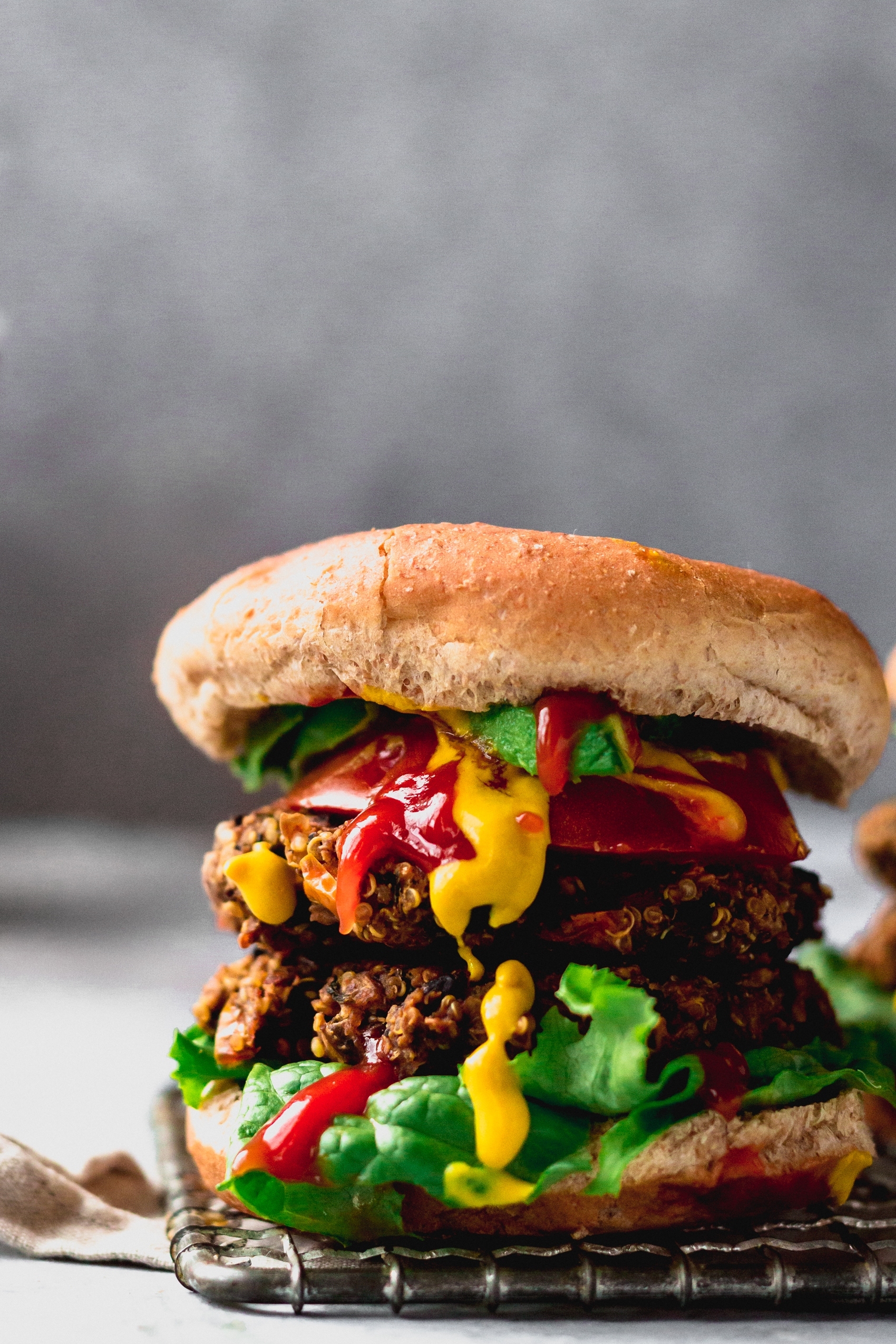 a veggie burger topped with lettuce, mustard and ketchup