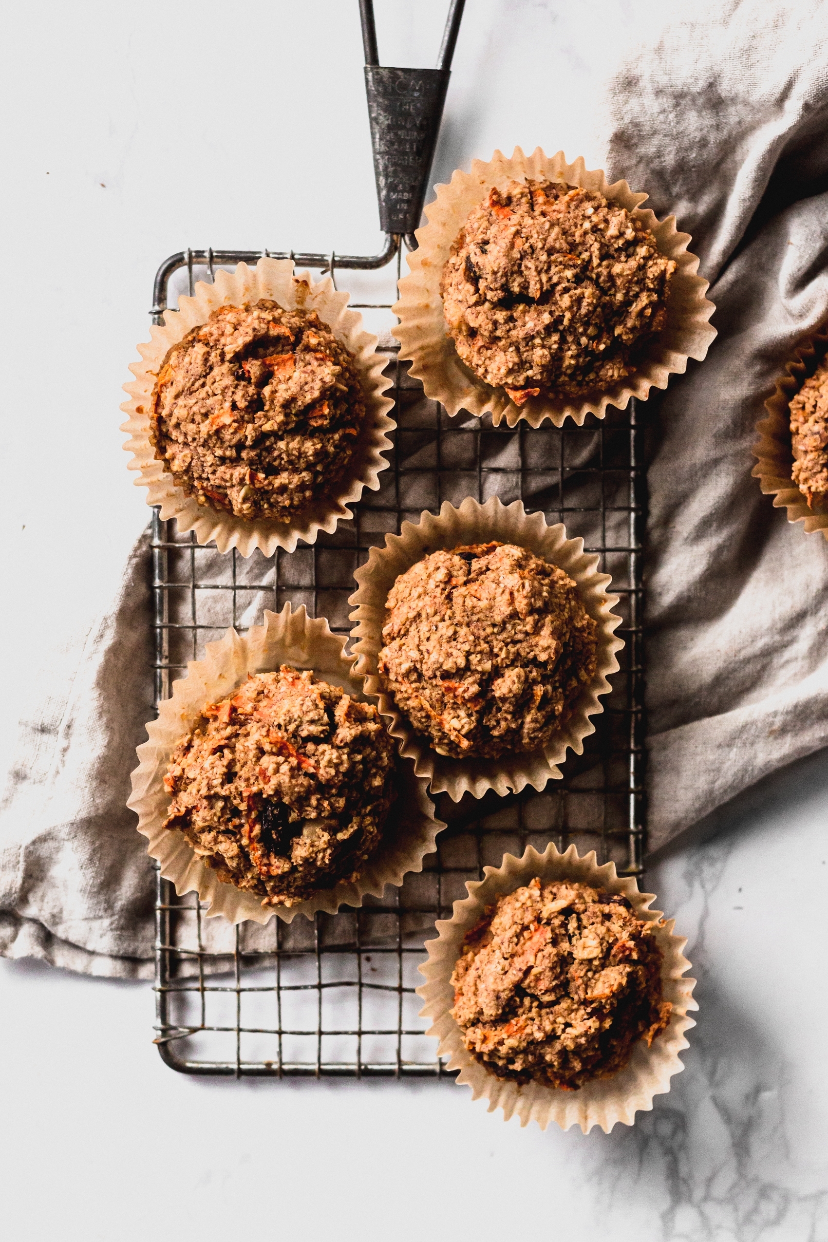 a cooling rack holding a batch of carrot cake muffins