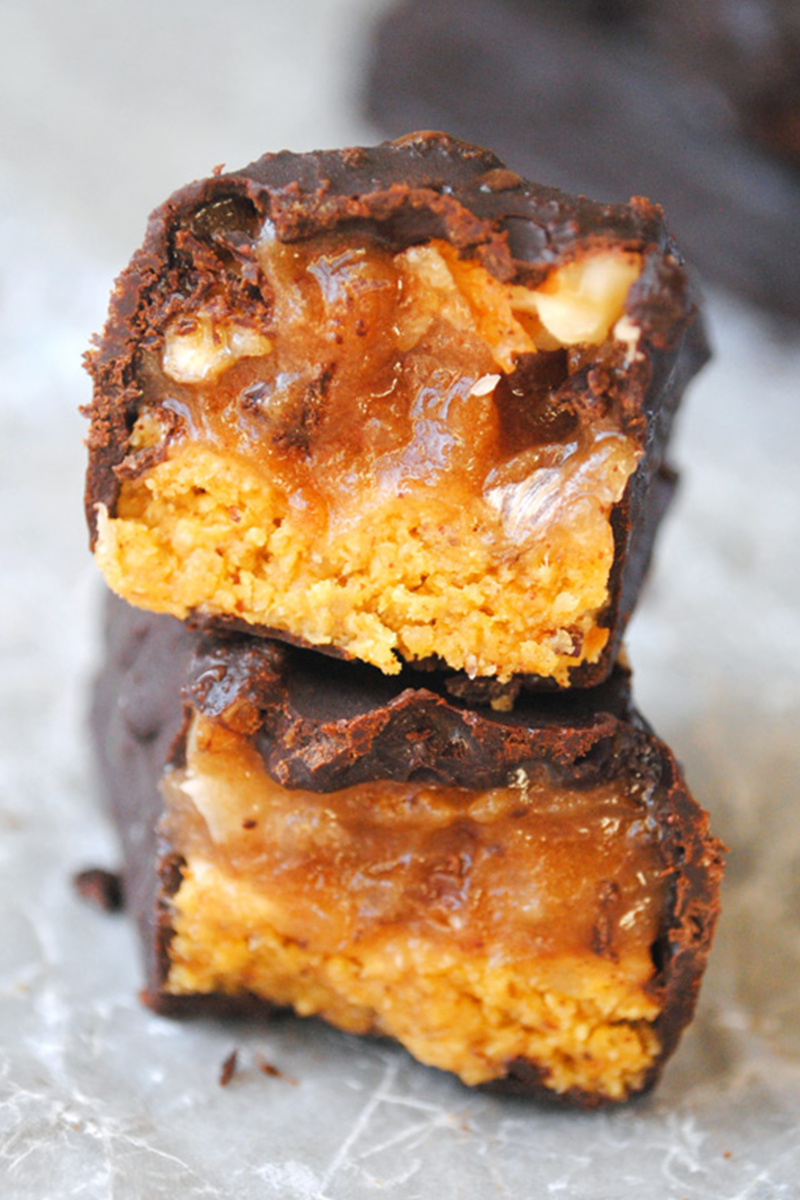 a close up of a homemade pumpkin candy bar sliced in half