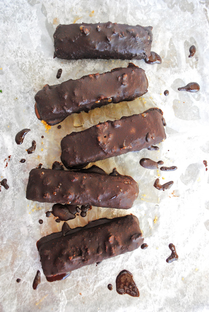 five homemade vegan candy bars on a sheet of parchment paper