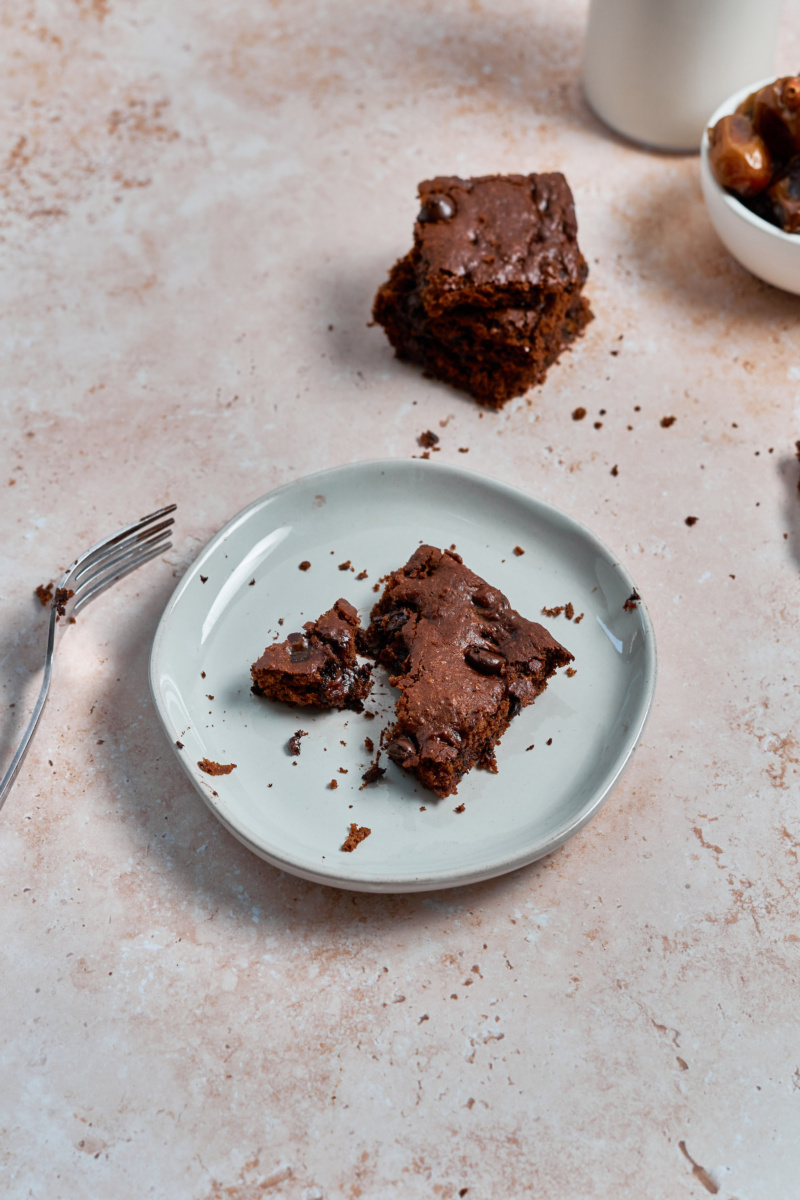 a small plate with an almond butter chocolate chip blondie 