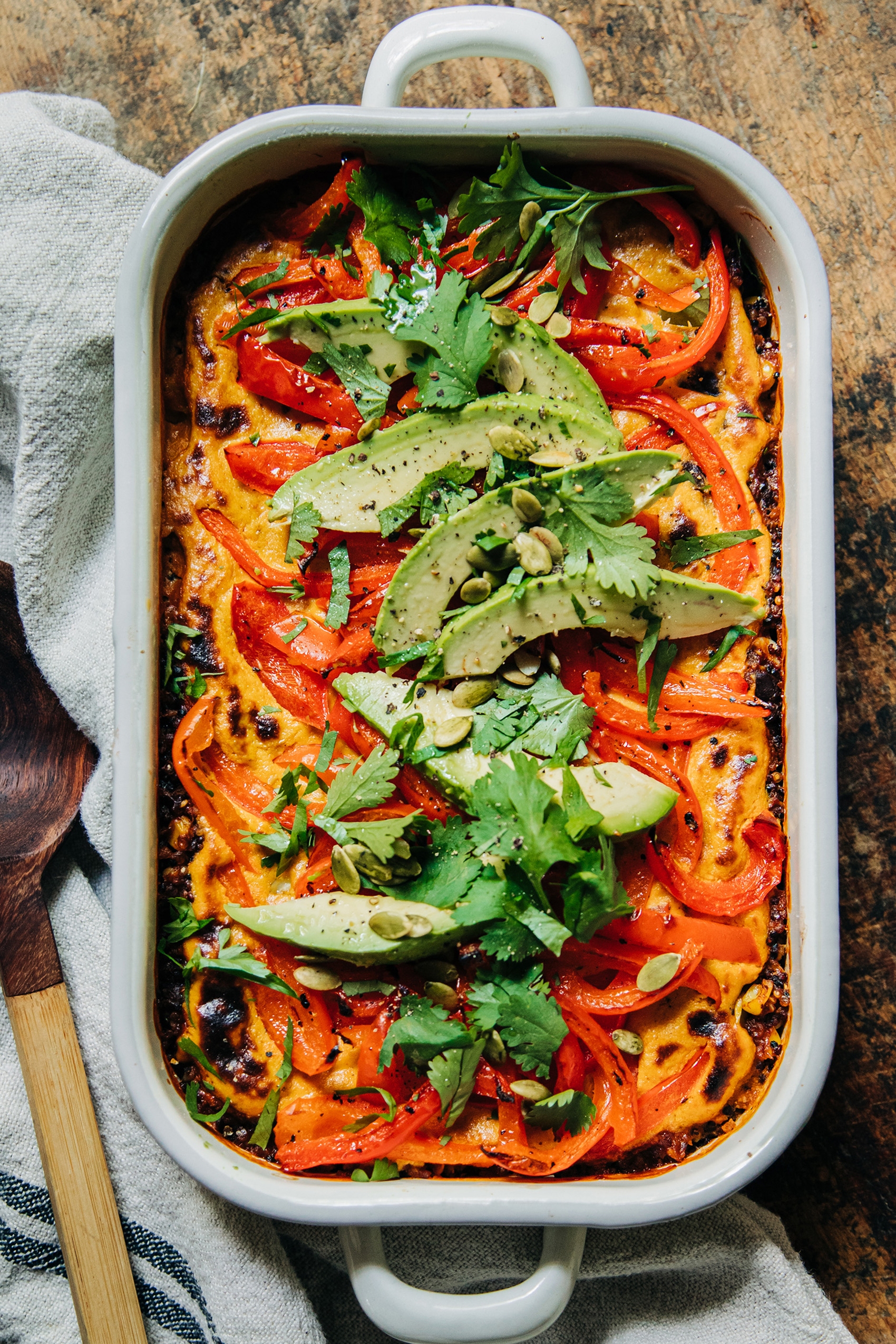 a stuffed pepper casserole topped with sliced avocado