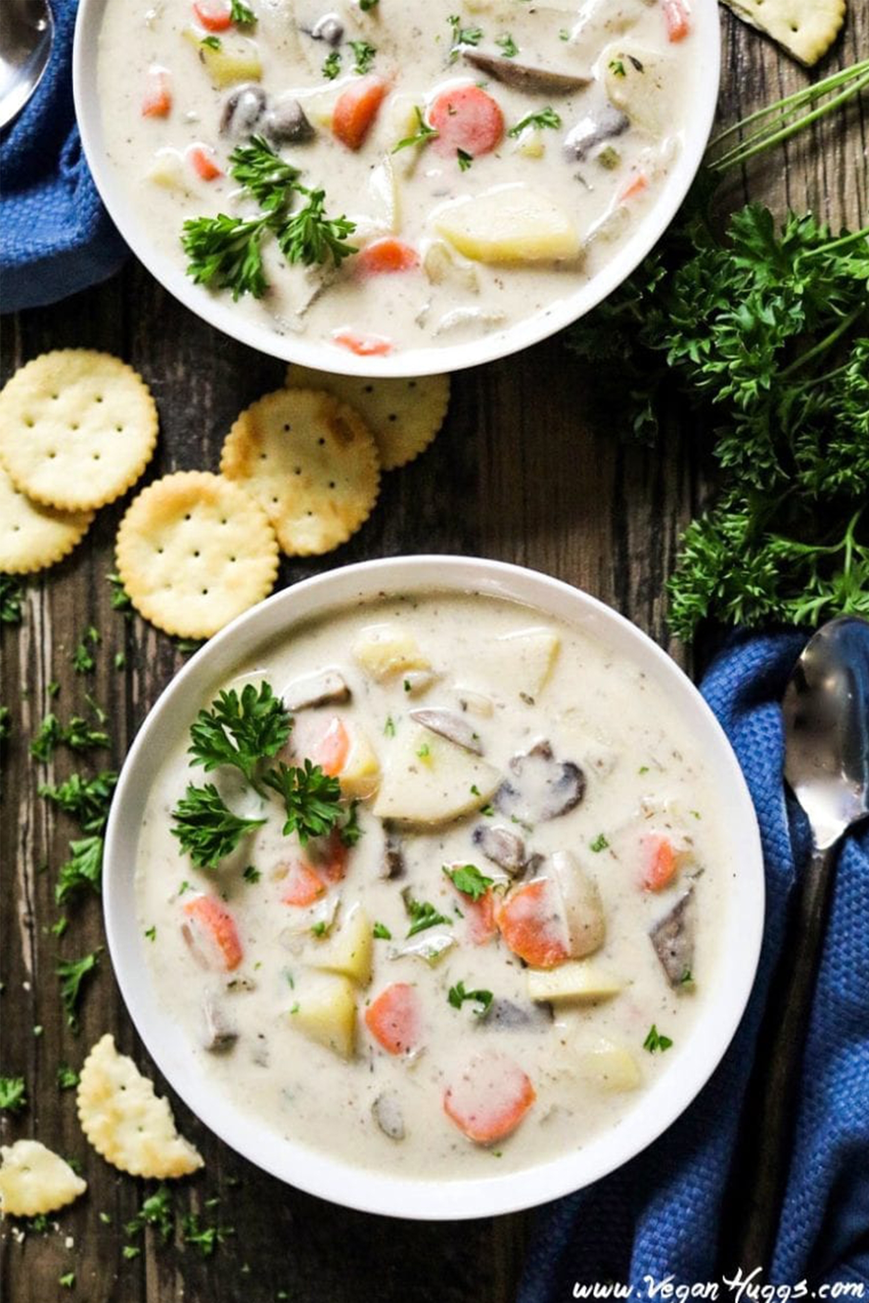 two bowls of vegan clam chowder served with crackers