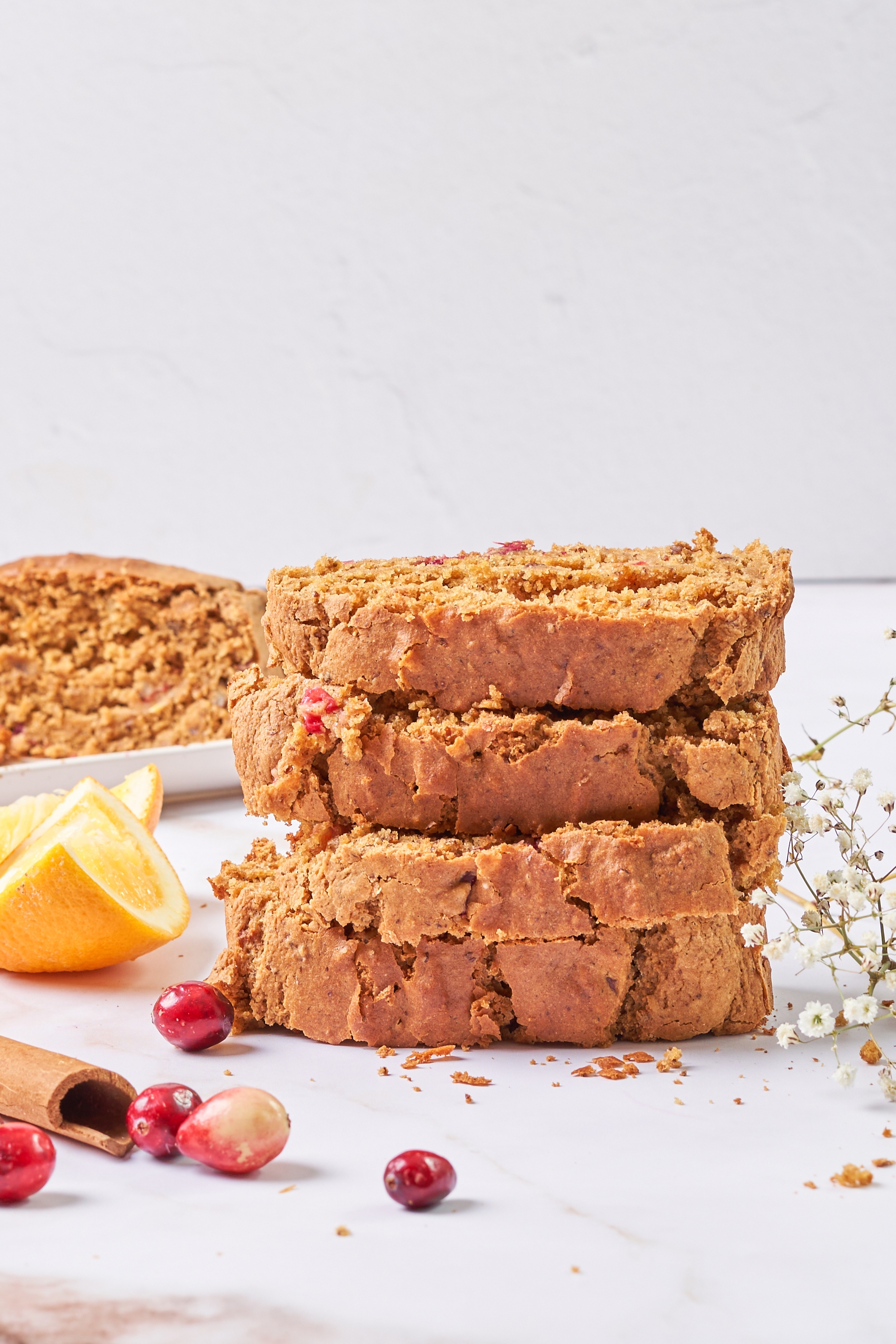 a stack of four slices of orange cranberry bread