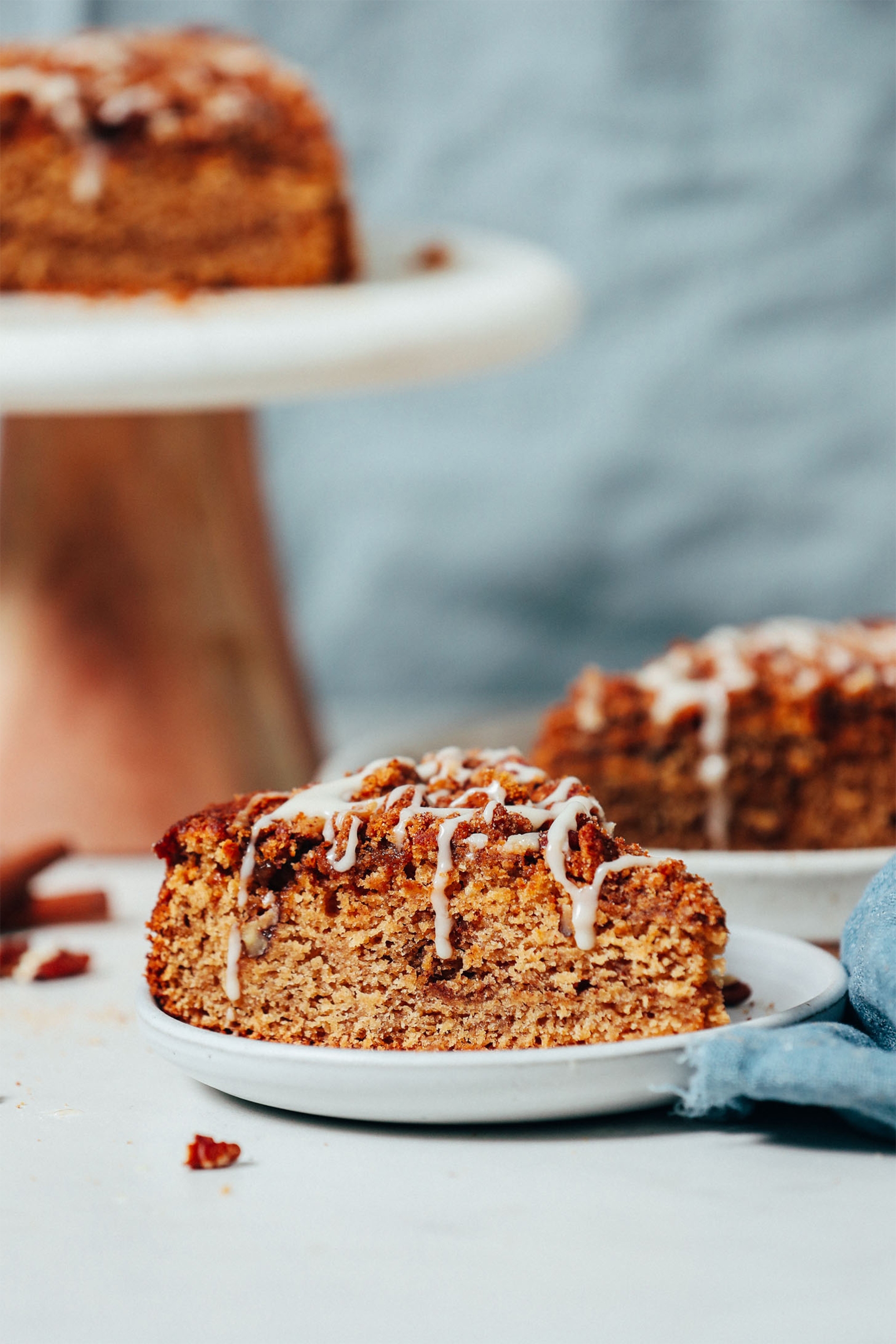 a slice of cinnamon coffee cake topped with vanilla icing