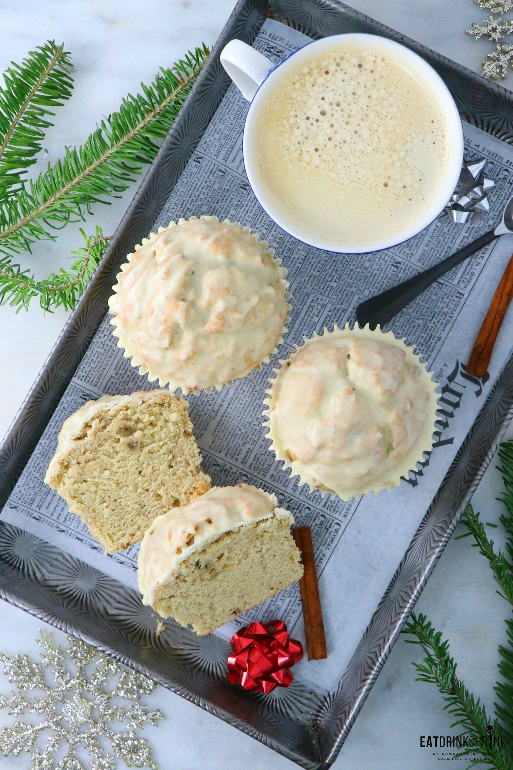 three vegan eggnog cupcakes, one of which is sliced in half