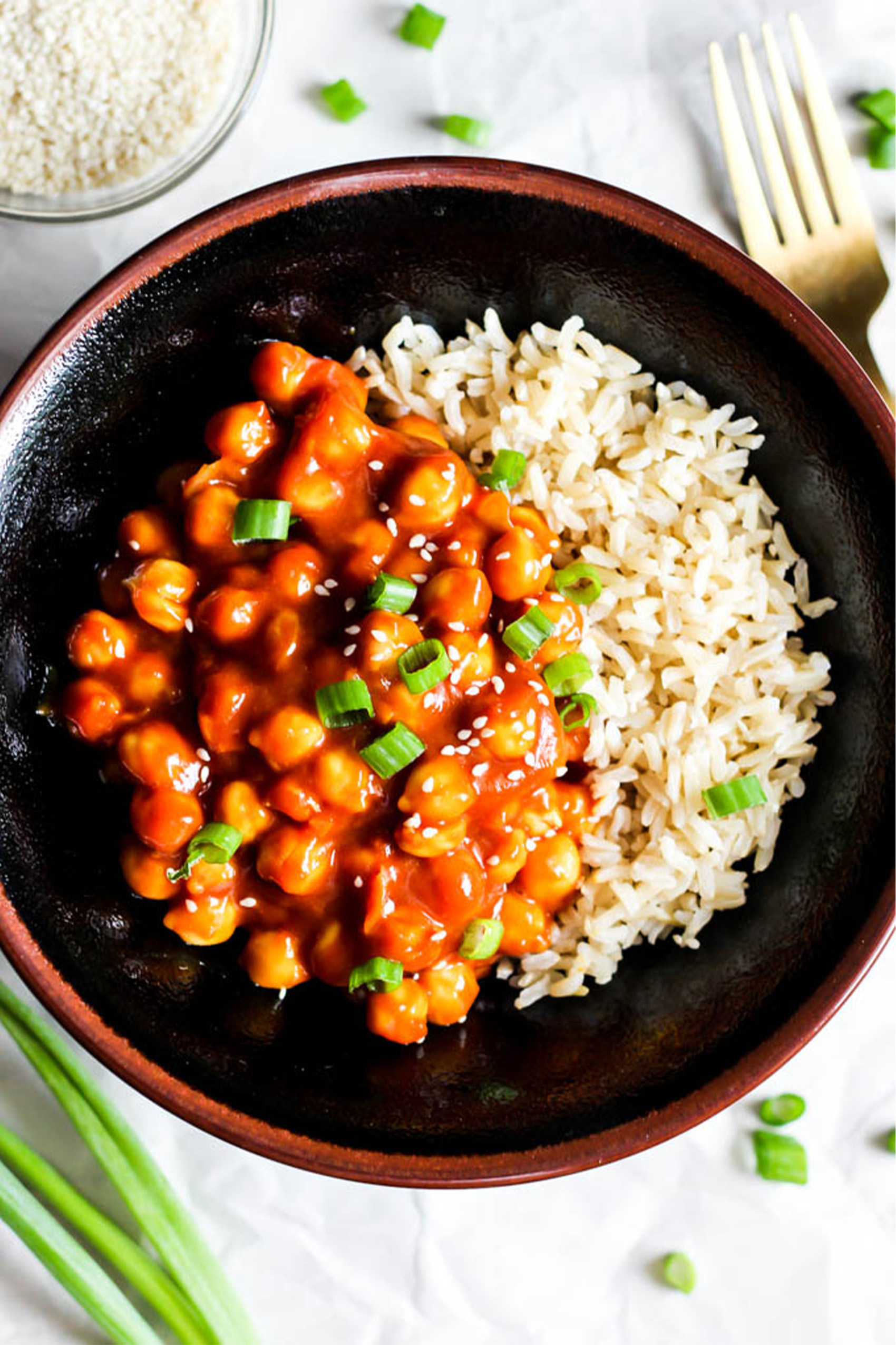 a bowl of rice topped with sweet and sour chickpeas