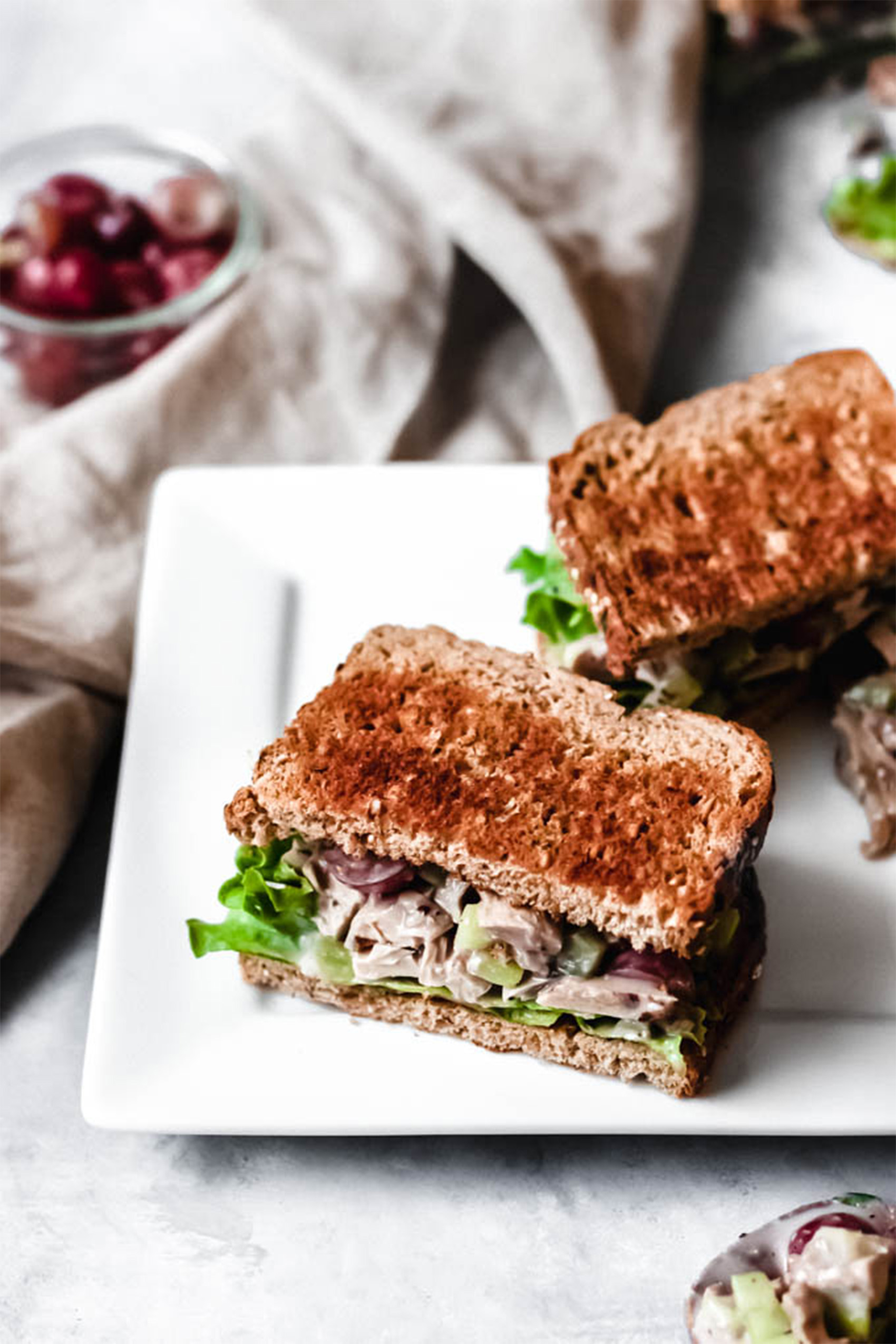 two halves of chicken salad sandwiches served on toasted bread