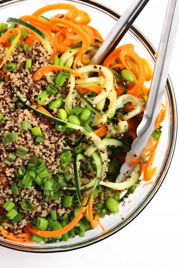 Step up your salad game with this healthy Asian Quinoa Salad featuring cucumber and carrot noodles! The creamy peanut dressing is the perfect complement.