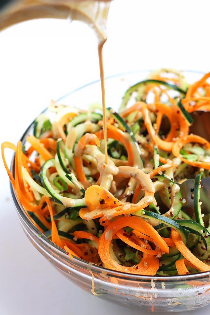 Step up your salad game with this healthy Asian Quinoa Salad featuring cucumber and carrot noodles! The creamy peanut dressing is the perfect complement.