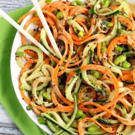 Step up your salad game with this healthy Asian Quinoa Salad featuring cucumber and carrot noodles! The creamy peanut dressing is the perfect complement.