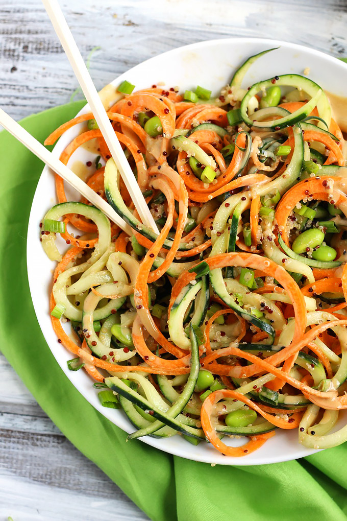 Step up your salad game with this healthy Asian Quinoa Salad featuring cucumber and carrot noodles! The creamy peanut dressing is the perfect complement.