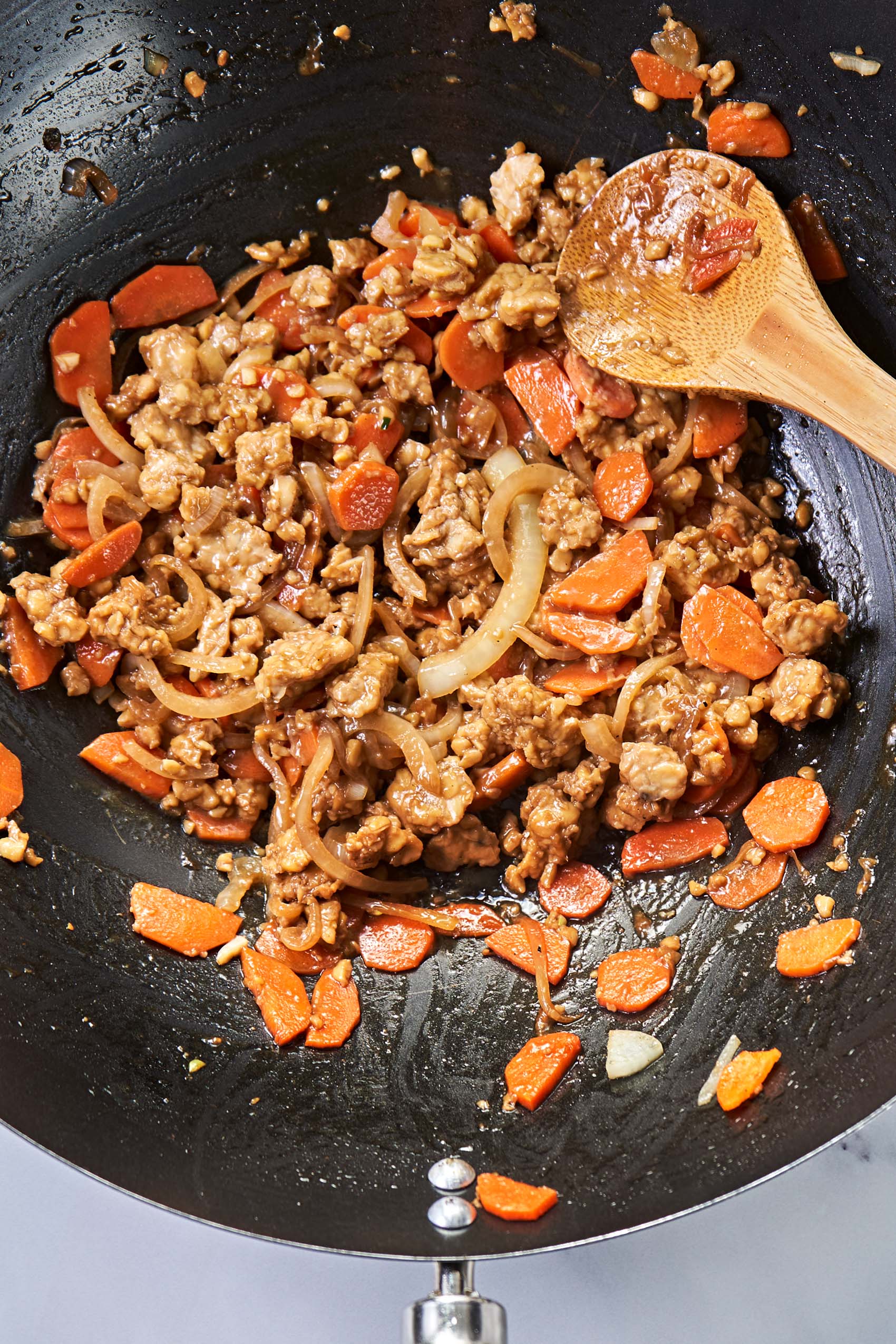 a pan of stir fried tempeh, carrots and onions