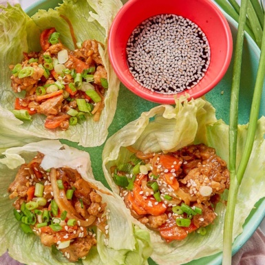 three lettuce cups stuffed with a teriyaki tempeh filling and served with soy sauce