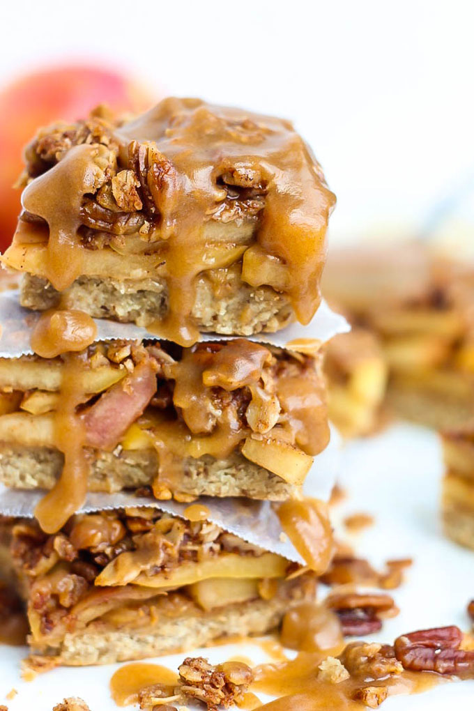 a stack of three apple pie bars topped with caramel