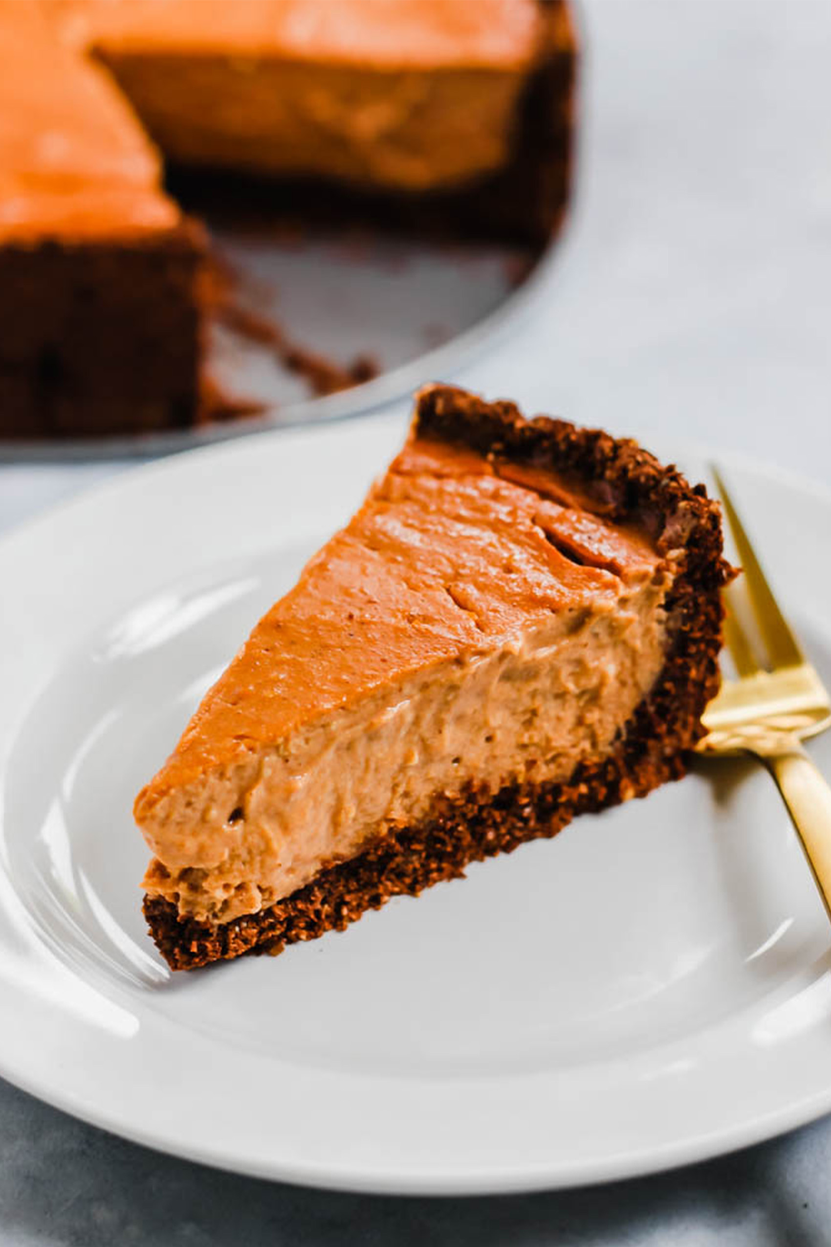 a pumpkin vegan cheesecake with a chocolate crust