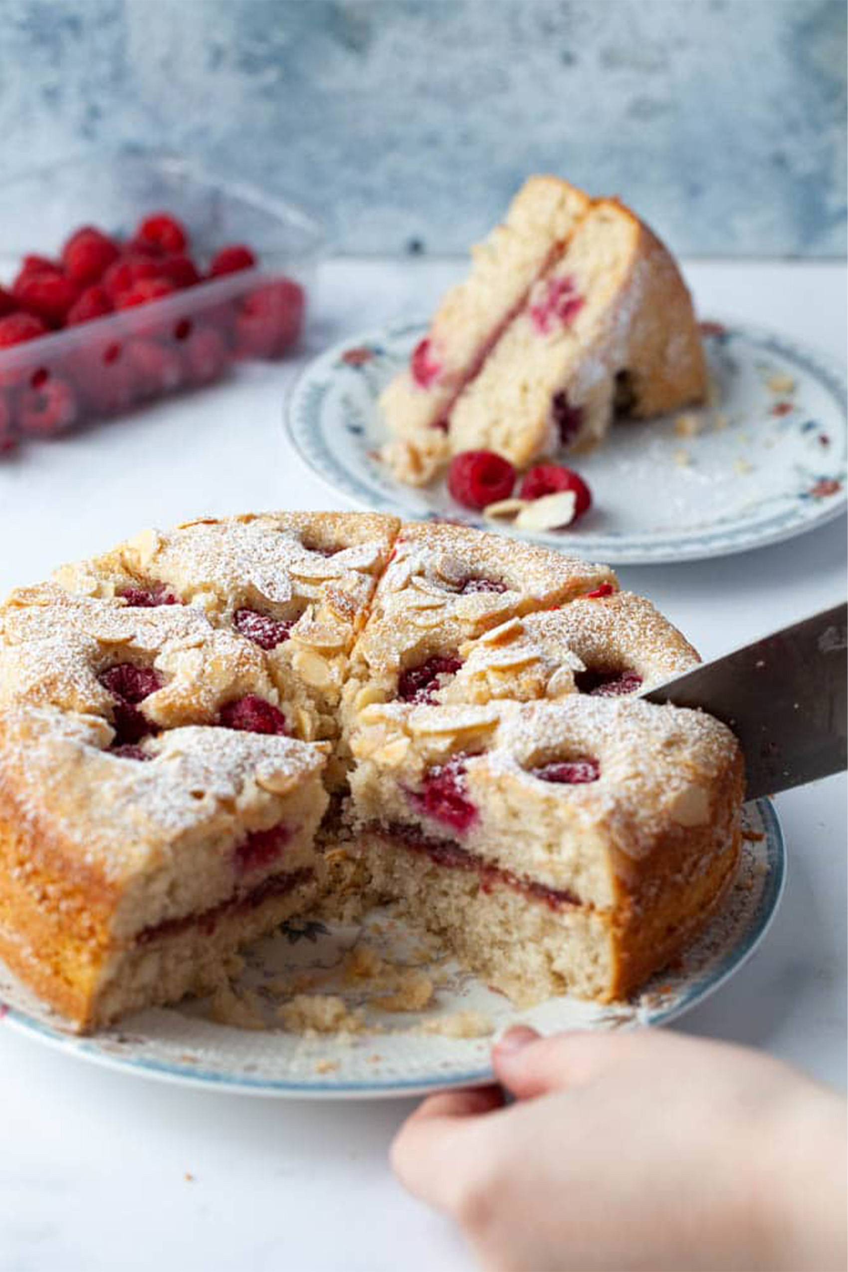 a raspberry vegan cake being slices