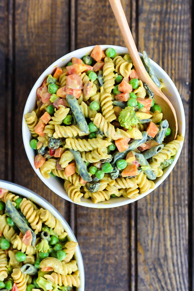 a bowl of vegan pasta salad with a curry silken tofu sauce