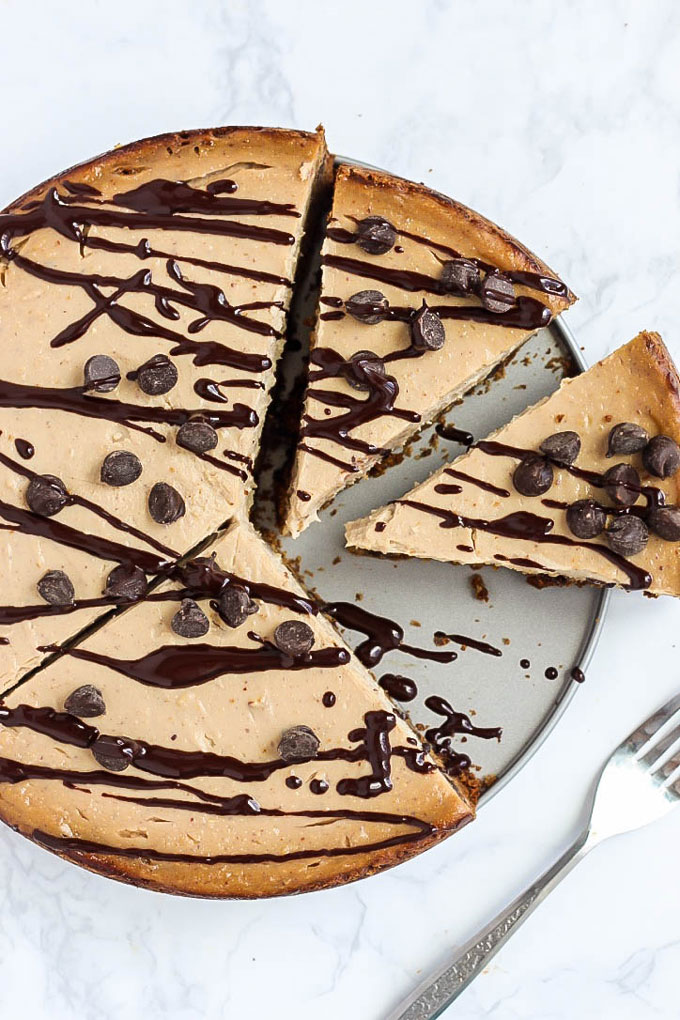 two slices carved out of a whole vegan chocolate chip cheesecake