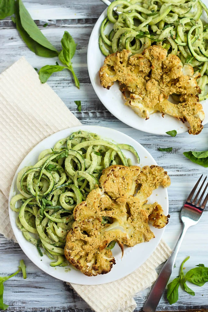 These Vegan Parmesan Cauliflower Steaks over Hemp Pesto Zoodles feel gourmet but are done in 1 hour! This gluten-free dinner is perfect to impress anyone.