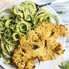 These Vegan Parmesan Cauliflower Steaks over Hemp Pesto Zoodles feel gourmet but are done in 1 hour! This gluten-free dinner is perfect to impress anyone.