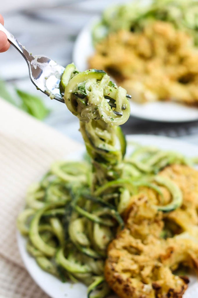 These Vegan Parmesan Cauliflower Steaks over Hemp Pesto Zoodles feel gourmet but are done in 1 hour! This gluten-free dinner is perfect to impress anyone.