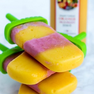 Satisfy your sweet tooth with these healthier Vegan Strawberry Orange Mango Popsicles! Only a few ingredients for a delicious treat that will cool you off.