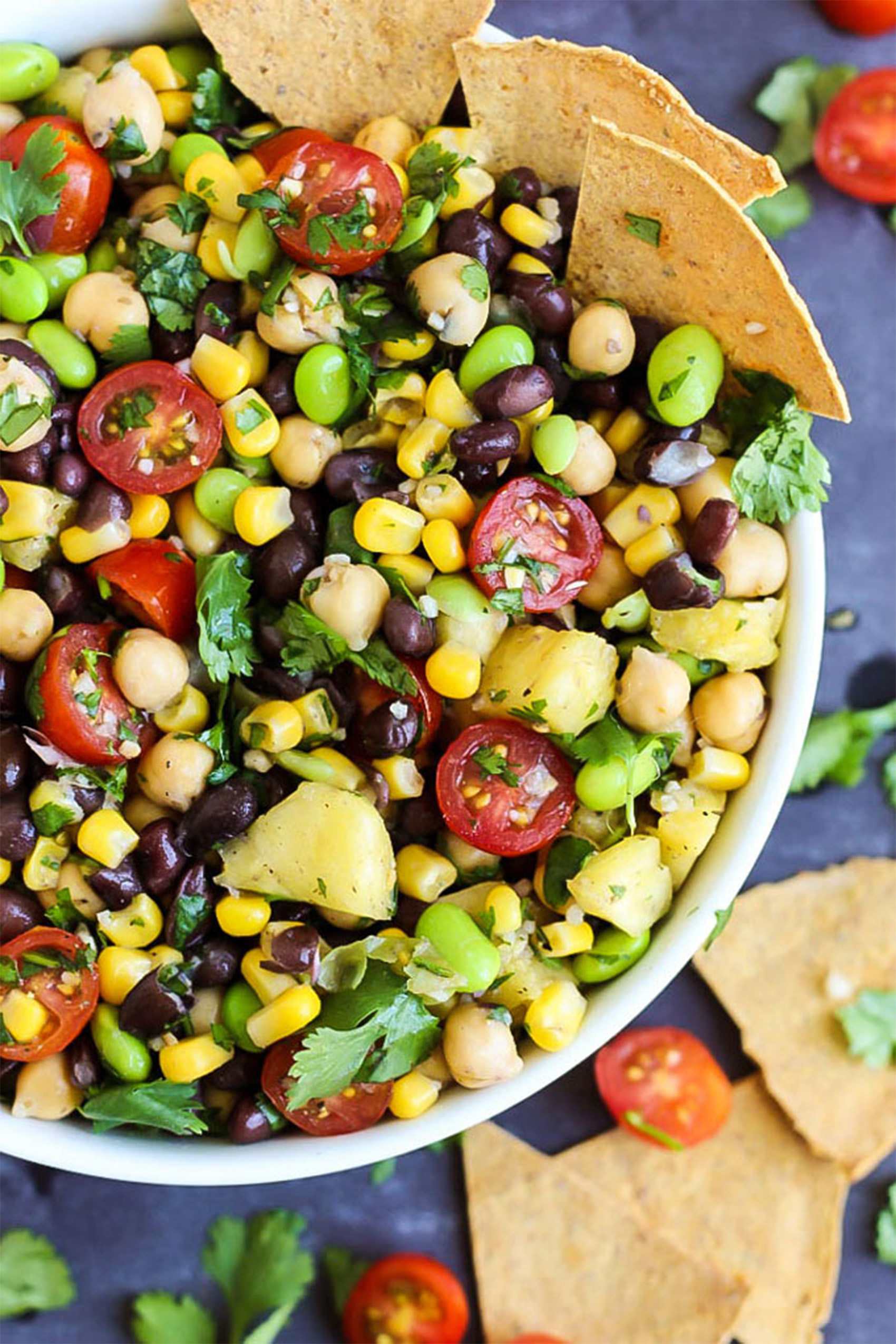 a bowl of pineapple bean salad served with tortilla chips