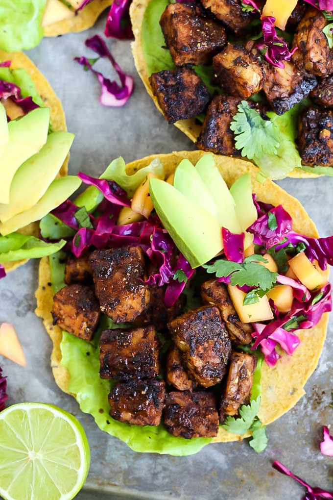 smoky tempeh served on top of a tostada with mango slaw, cabbage and avocado