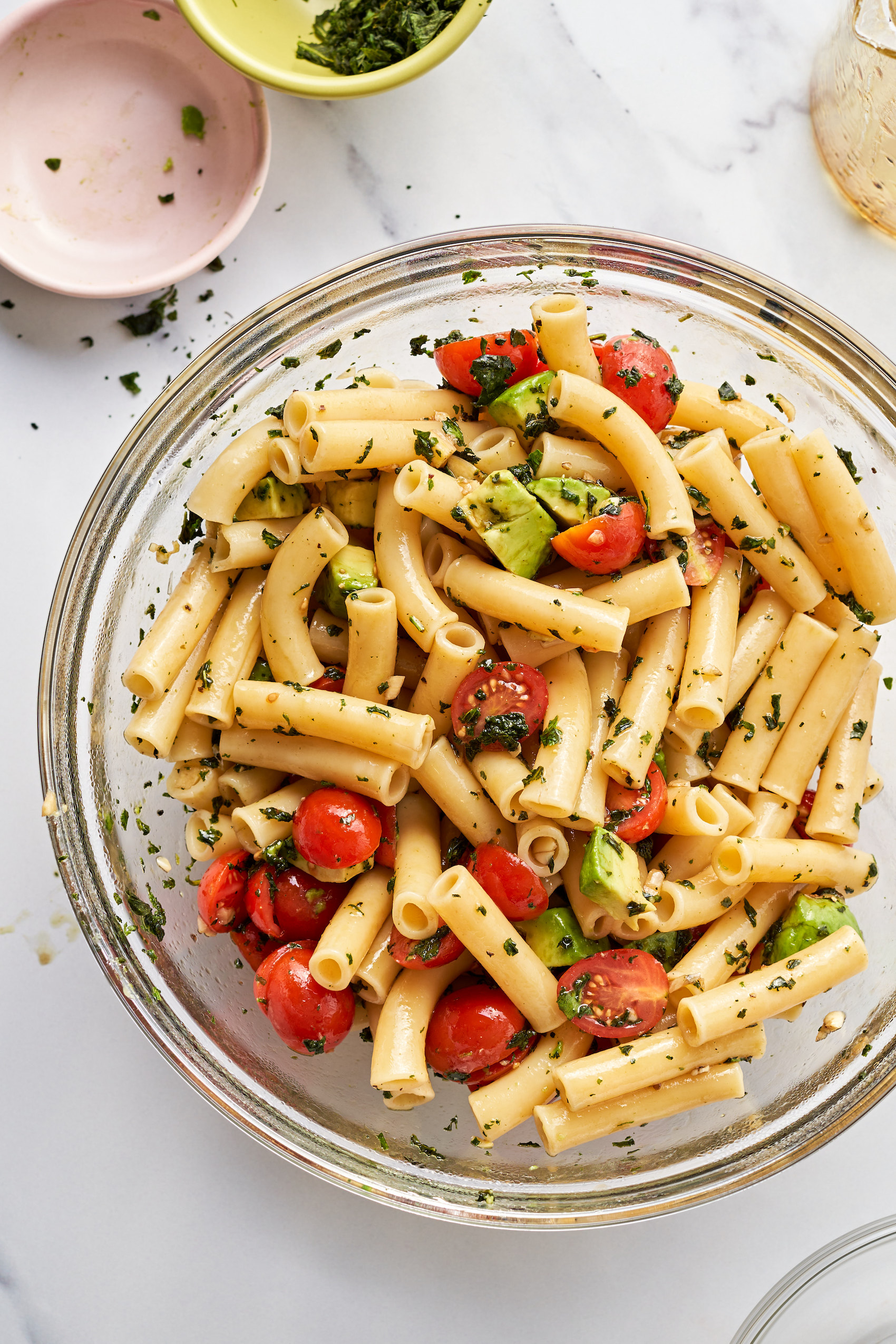 a close up of a large bowl of tossed pasta salad
