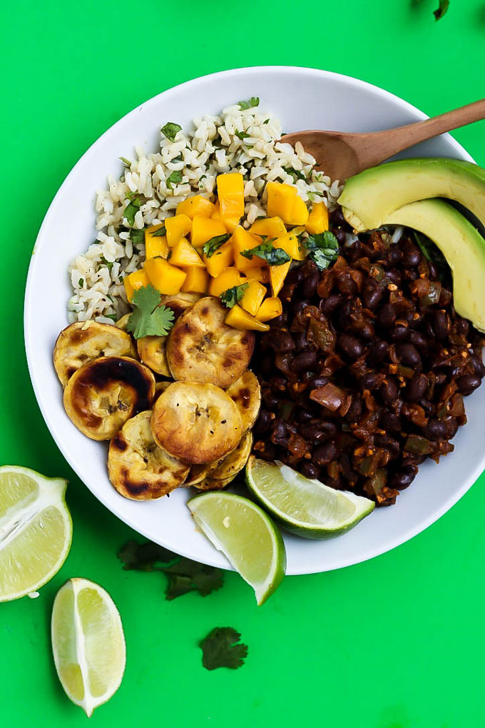 With a little heat and lots of flavor, these Black Bean Cilantro Lime Rice Bowls with Plantains make a healthy dinner or lunch recipe! Your burrito bowl night just got a whole lot better. V + GF.