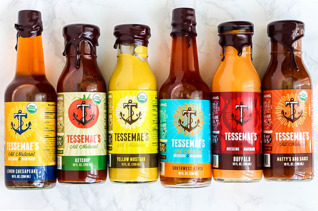 a collection of bottles of Tessemae's sauces