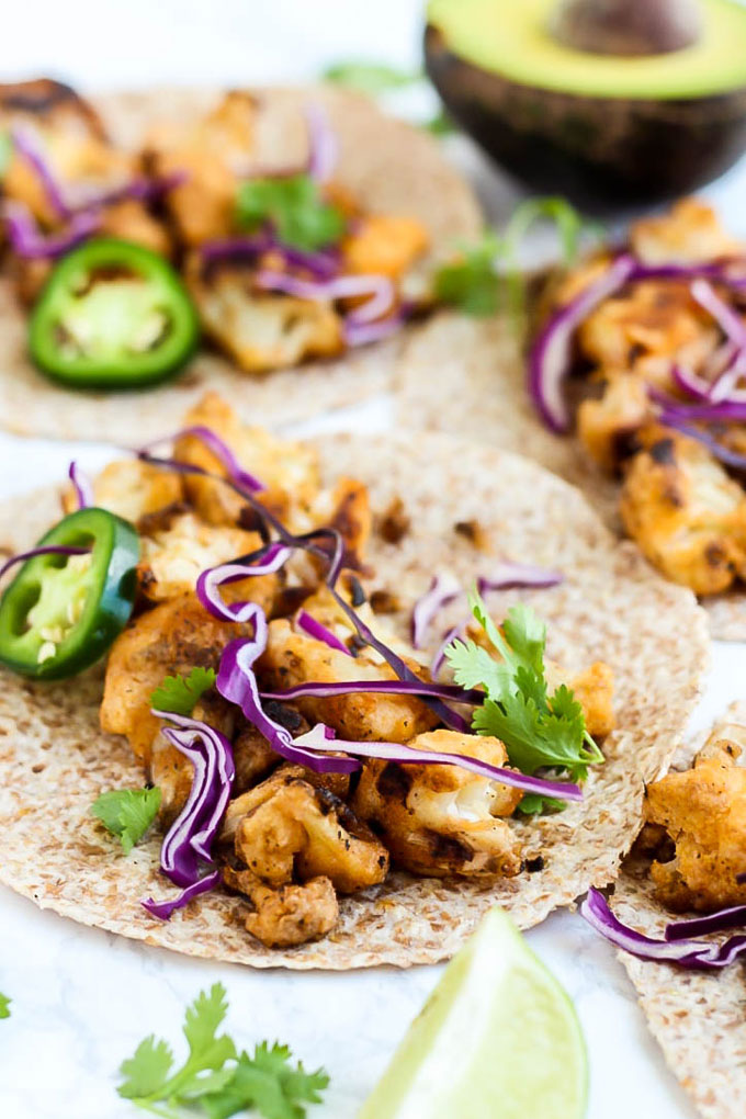 tortillas topped with buffalo cauliflower, cabbage and jalapenos