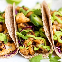 These Vegan Buffalo Cauliflower Tacos with Avocado Cilantro Sauce are PACKED with flavor & a healthy option for taco night! Vegan, gluten-free & delicious.
