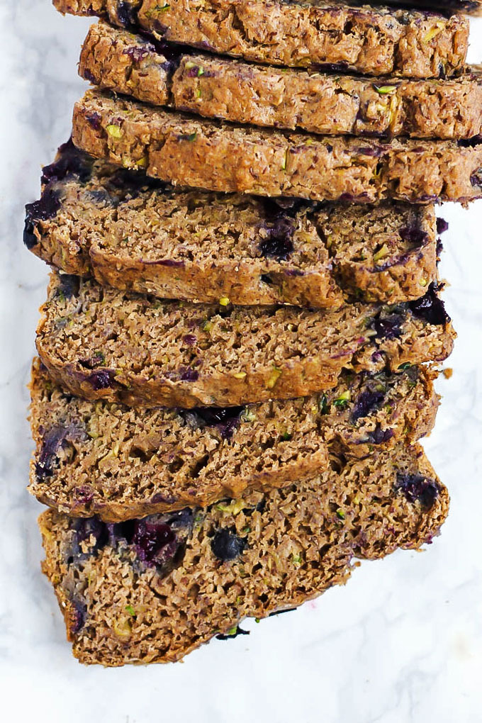 seven slices of blueberry zucchini bread lined up in a row