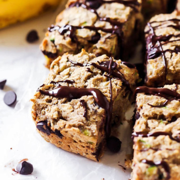 a batch of pre-sliced oatmeal chocolate chip breakfast bars surrounded by chocolate chips