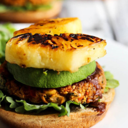 a chickpea burger topped with grilled pineapple