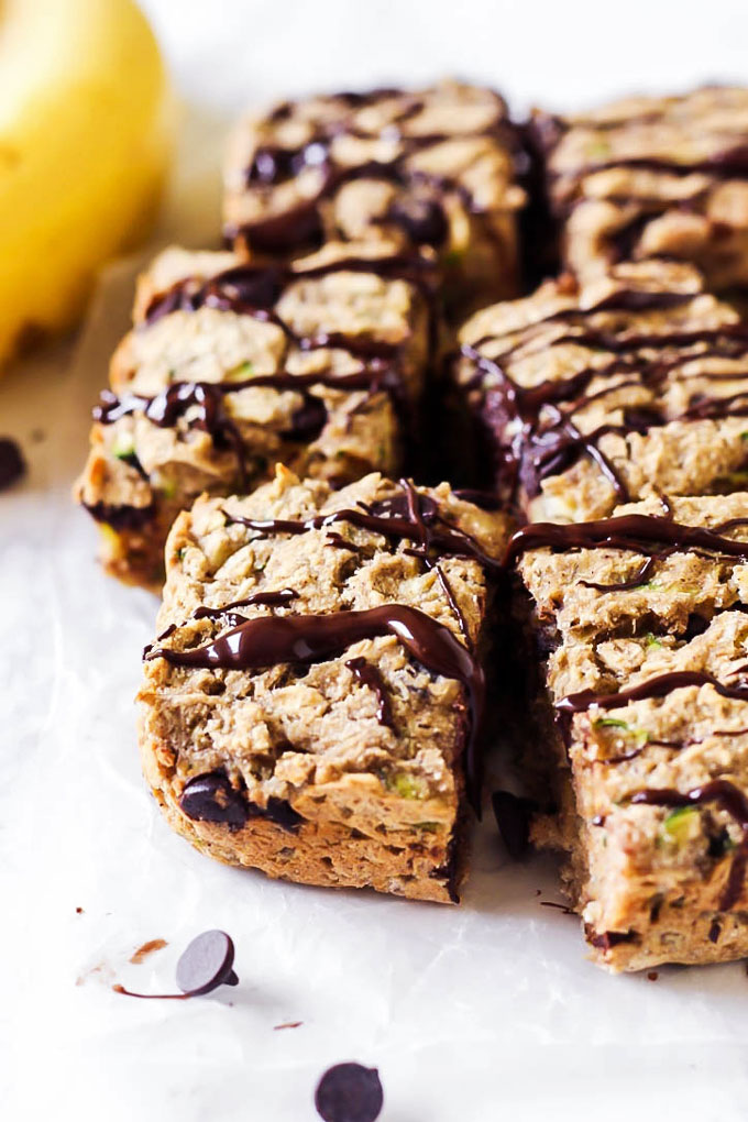 a batch of breakfast bars topped with a chocolate drizzle