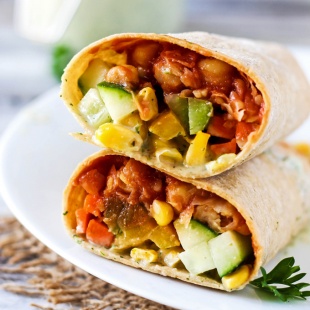 A smoky, savory Vegan BBQ Chickpea Wrap is the perfect lunch to pack for work or school! Stuff it with fresh vegetables for a healthy, satisfying meal.