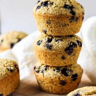 a stack of three blueberry cornmeal muffins