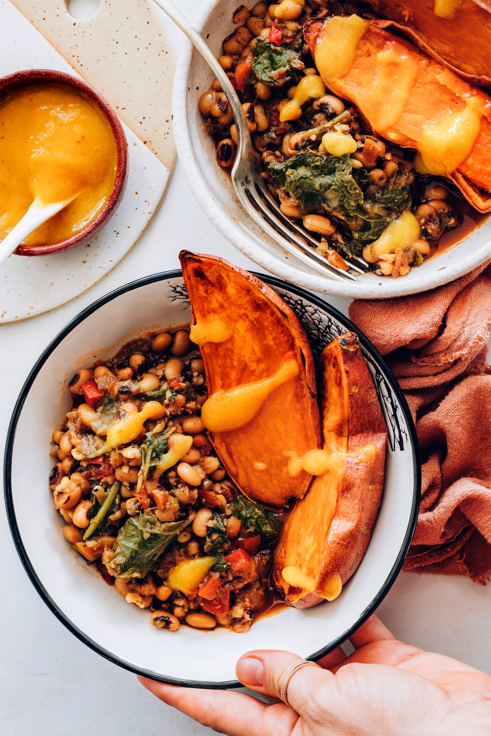 a sweet potato bowl served with spiced black eyed peas and greens