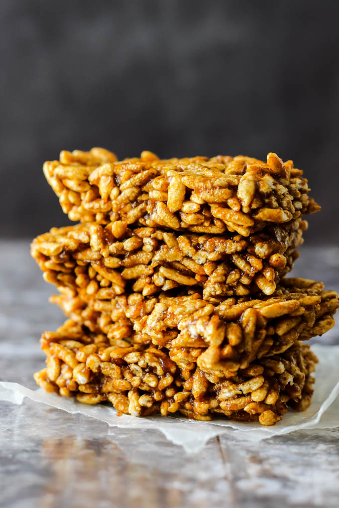 four square slices of homemade rice crispy treats stacked on top of each other