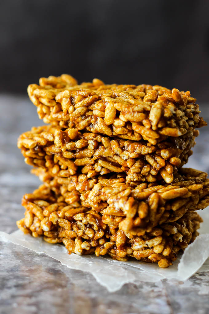 four pumpkin spice rice crispy treats stacked one on top of the other