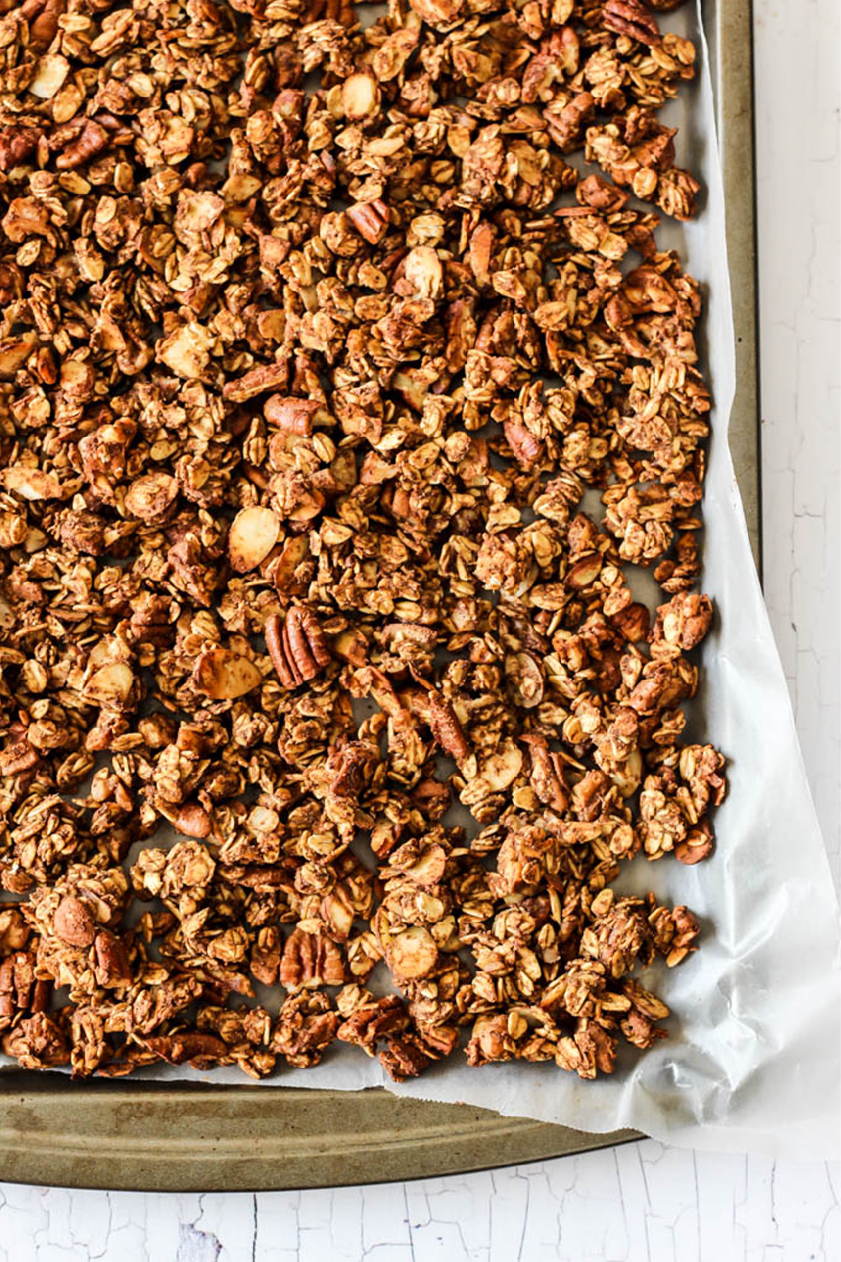 homemade granola on a parchment lined sheet tray 