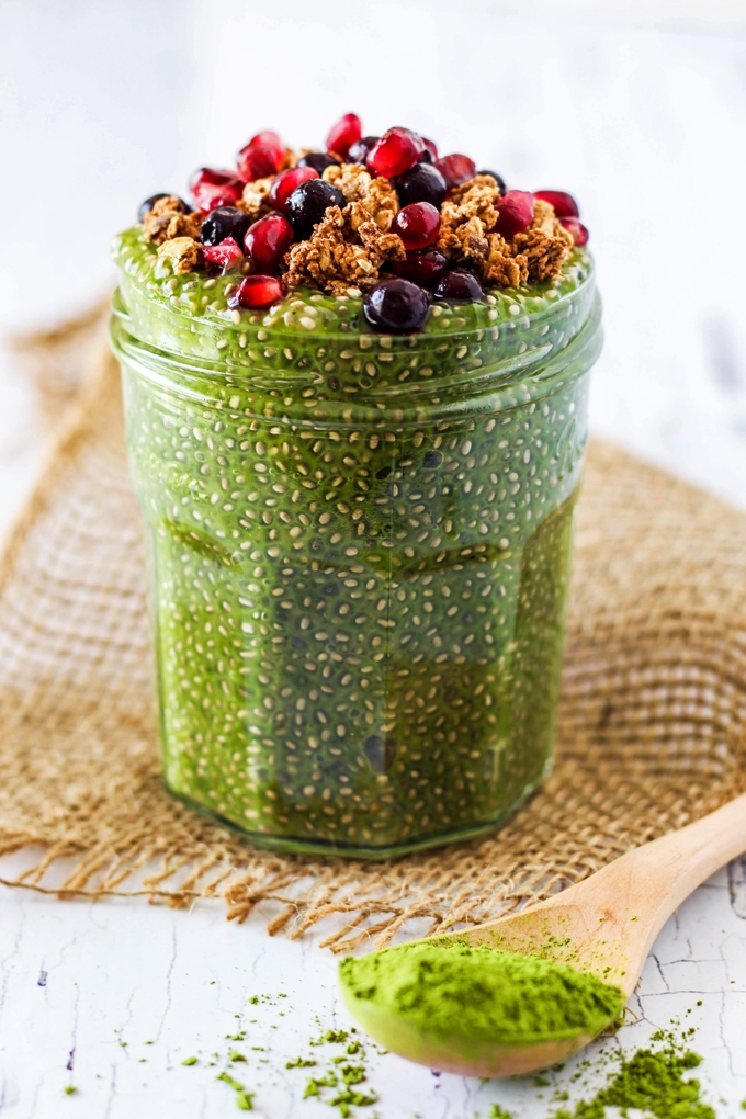 a spoonful of matcha powder next to a jar of matcha chia pudding