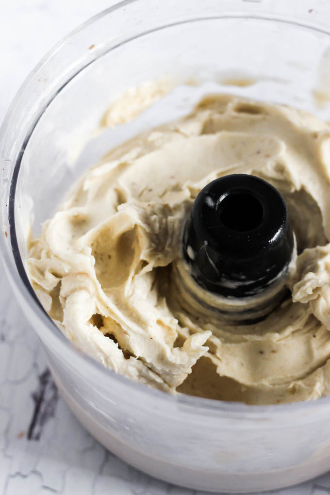 a food processor filled with blended frozen bananas