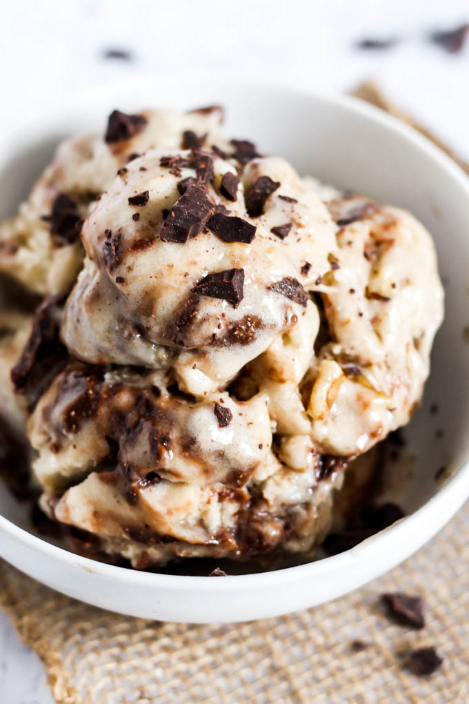 A bowl of homemade banana ice cream with brownie bits mixed throughout