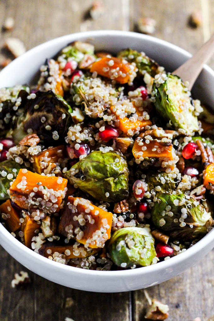 a brussels sprouts salad with butternut squash, quinoa and pomegranate seeds