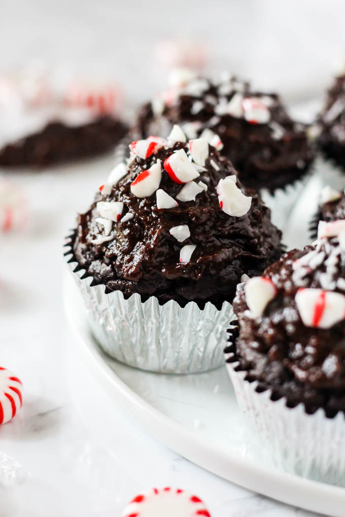 a plate of vegan chocolate cupcakes topped with peppermint crumbles